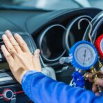 Repairman,Holding,Monitor,Tool,To,Check,And,Fixed,Car,Air