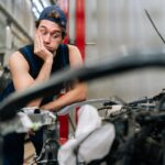 Portrait,Of,Puzzled,Mechanic,Male,With,Confused,Expression,Leaning,On