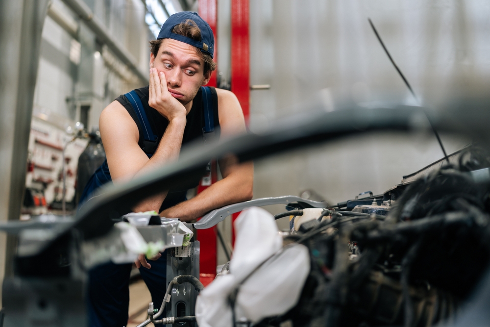 Portrait,Of,Puzzled,Mechanic,Male,With,Confused,Expression,Leaning,On