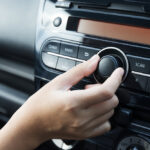 Women,Turning,Button,On,Car,Radio,For,Listening,To,Music