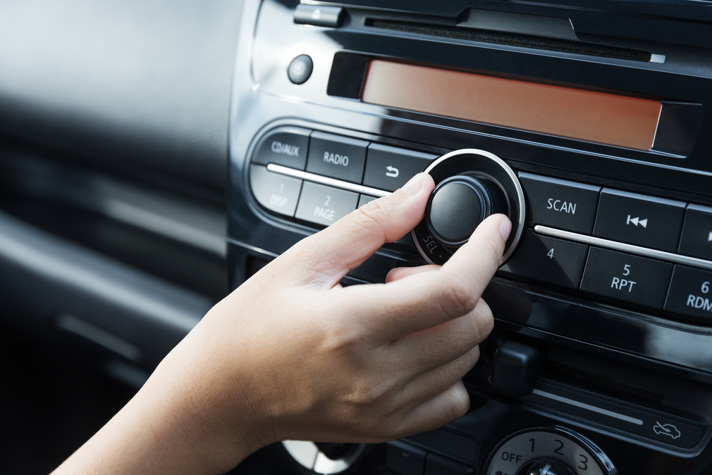 Women,Turning,Button,On,Car,Radio,For,Listening,To,Music