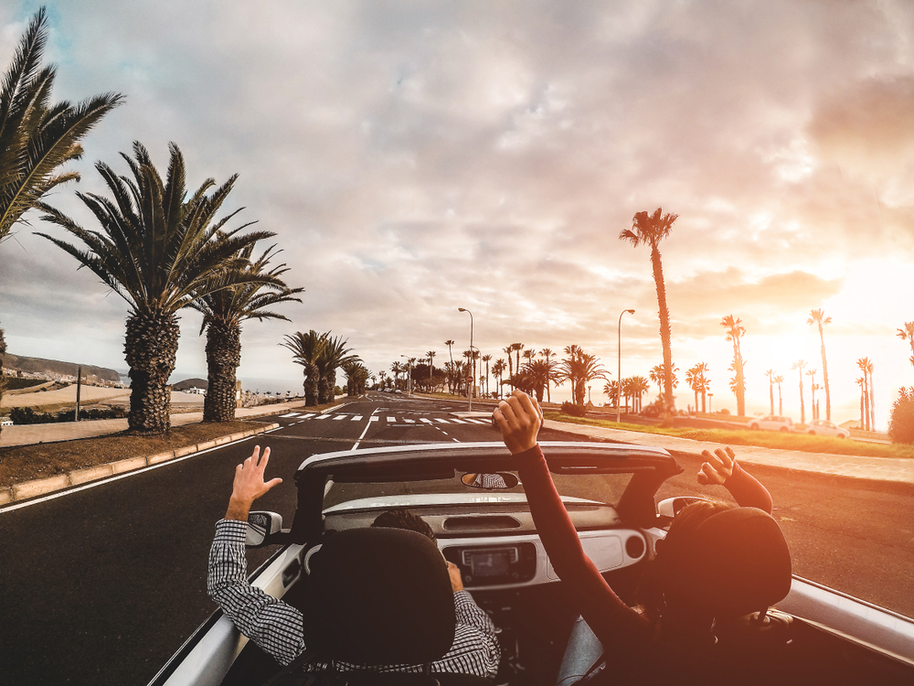 Happy,People,Having,Fun,In,Convertible,Car,In,Summer,Vacation